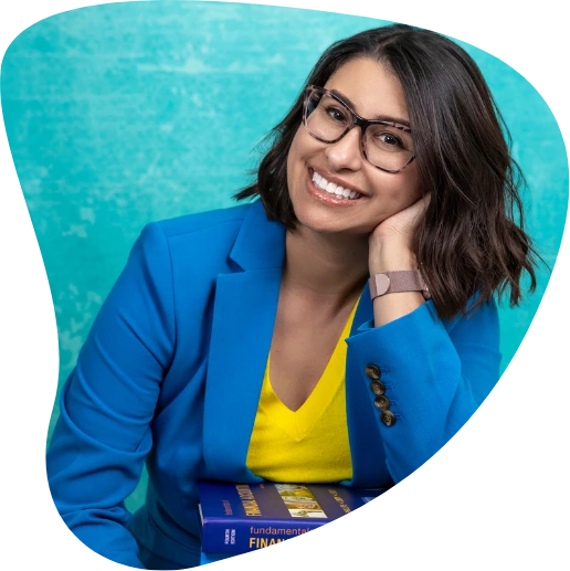Teresa Thompson smiling while leaning on a stack of accounting textbooks.